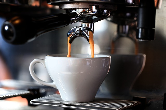 Coffee machine filling espresso into a white cup