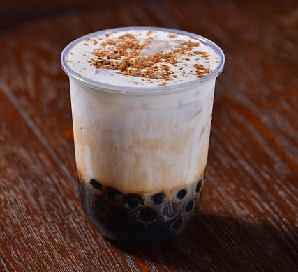 Bubble tea in a plastic cup on a wooden table