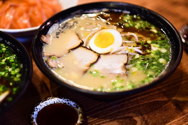 A bowl of soupy noodles with meat and egg on top